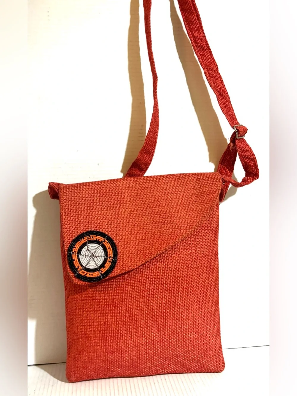 Handwoven Orange Crossbody Bag with Beaded Accent